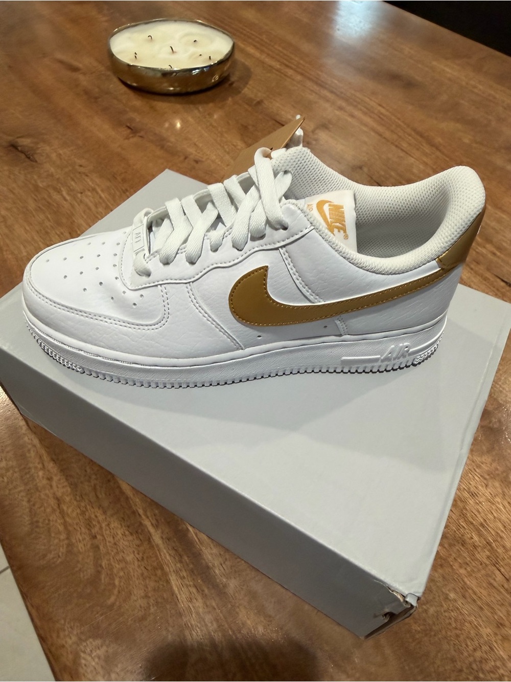 Nike Women's White Sneakers with Gold Swoosh